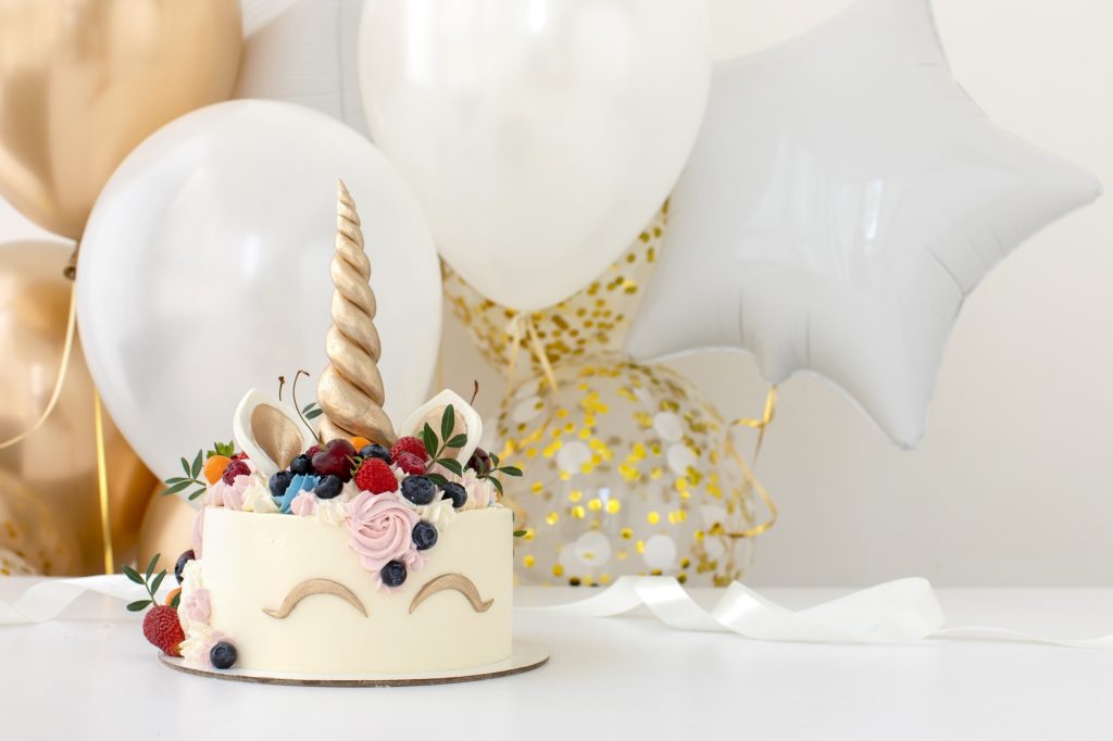 Birthday party table with unicorn cake