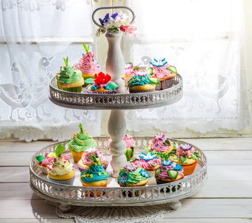 Delicious cupcakes with sweet decoration and cream