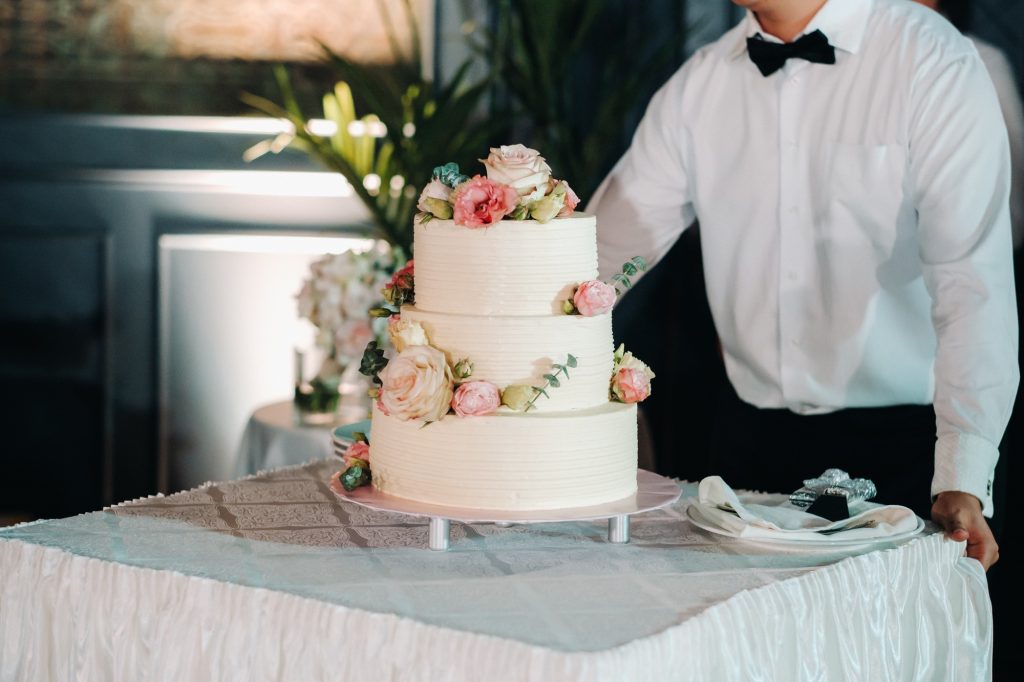 Elegant wedding cake at the wedding in three tiers