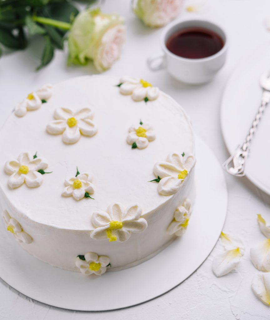 Elegant white floral cake with tea setting
