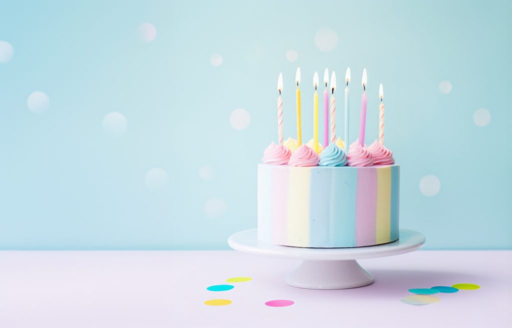 Pastel birthday cake with eight birthday cake candles