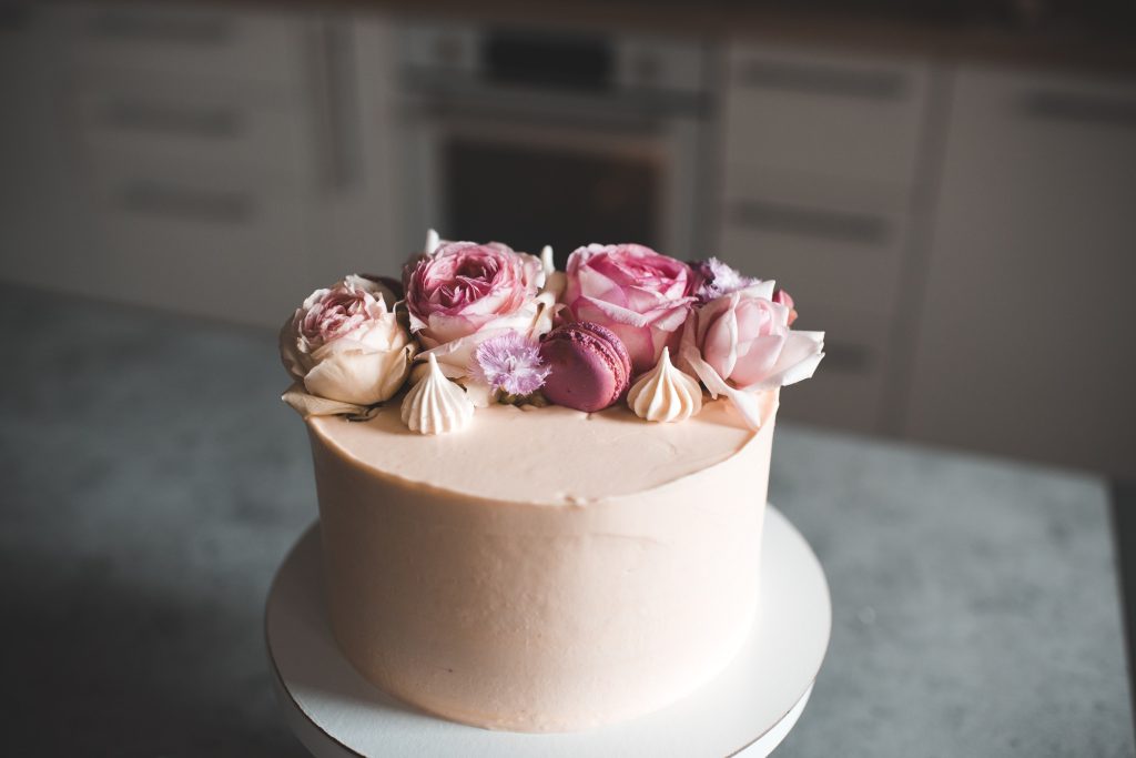 Tasty cake decorated with fresh flower roses